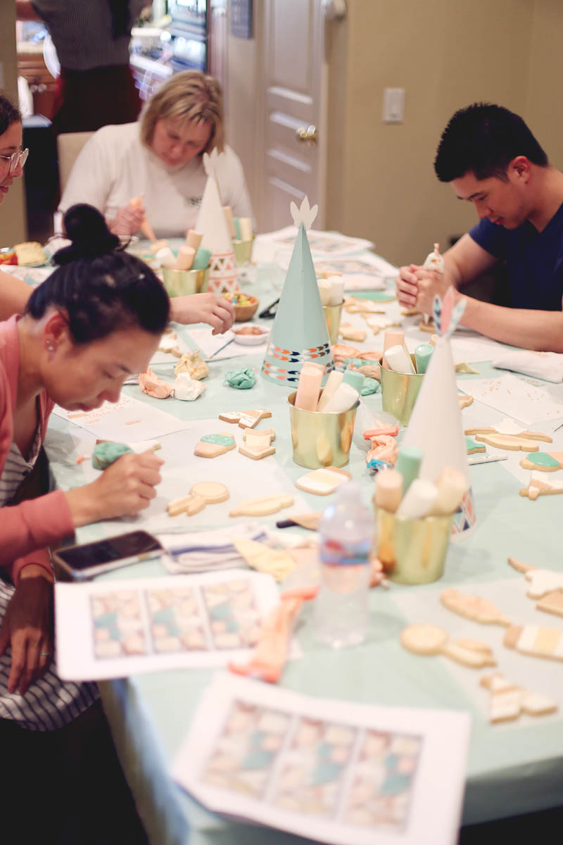students decorating cookies at a table