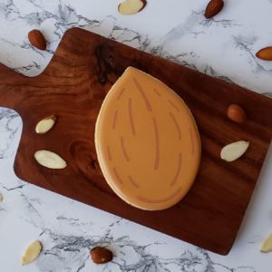 an almond shortbread sugar cookie decorated to look like and almond.