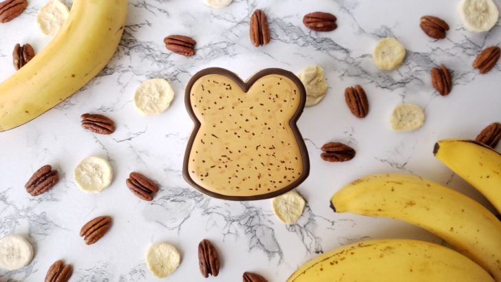 A single banana bread shortbread sugar cookie decorated to look like a slice of banana bread.