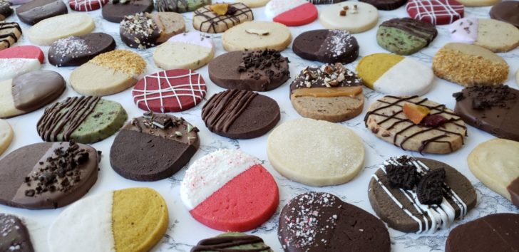A variety of slice-and-bake cookies arranged on a marble surface.
