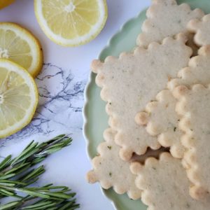 Lemon rosemary shortbread sugar cookies arranged on a plate