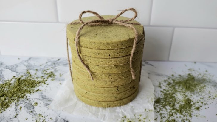 Stacked matcha green tea shortbread sugar cookies tied with twine.