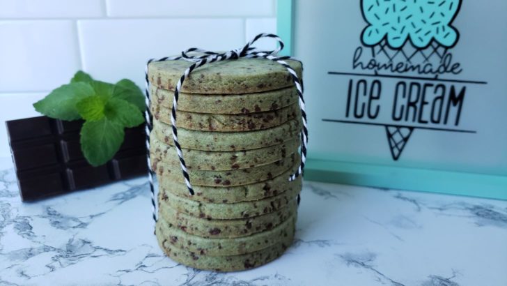 Stacked mint chip shortbread sugar cookies tied with a black and white ribbon. 