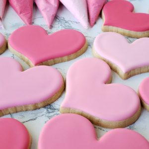 heart cookies decorated with pink royal icing