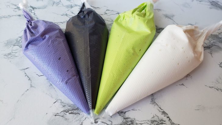 4 bags of royal icing. Purple, black, neon green, and white. 