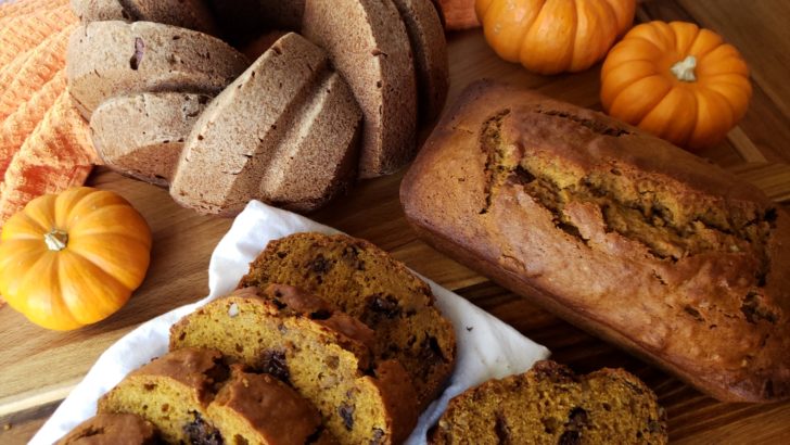 Loaves of pumpkin bread on a wooden table.